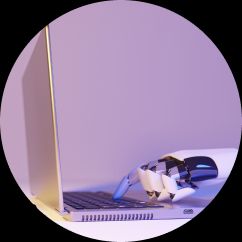 An electronic hand at a computer opposite a human hand with a pen and paper to represent manual and automated testing.