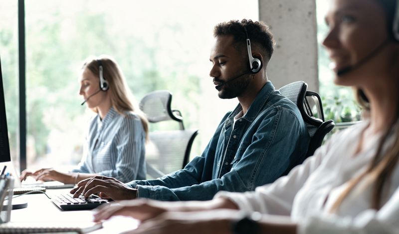 People sat at a desk with a headset on.