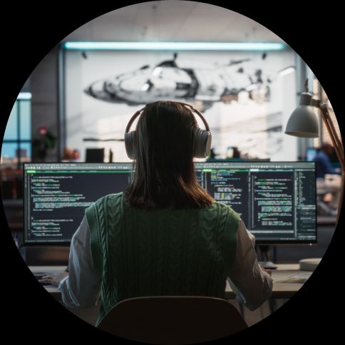 Women at computer screen with headphones on