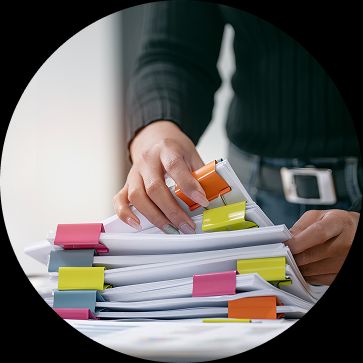 Learn what Test Management is. Pile of Test Management Folders with colourful clips.