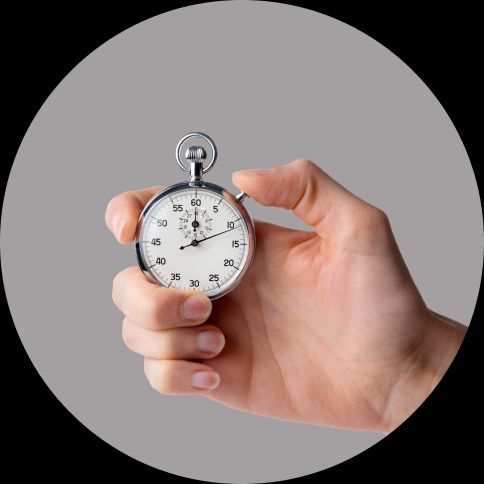 image of a stopwatch in a hand with a gray background